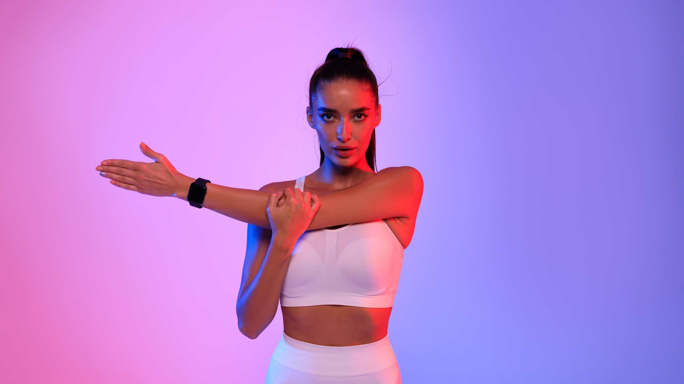 Fit Lady Stretching Arms Wearing Fitness Watch Exercising, Studio Shot